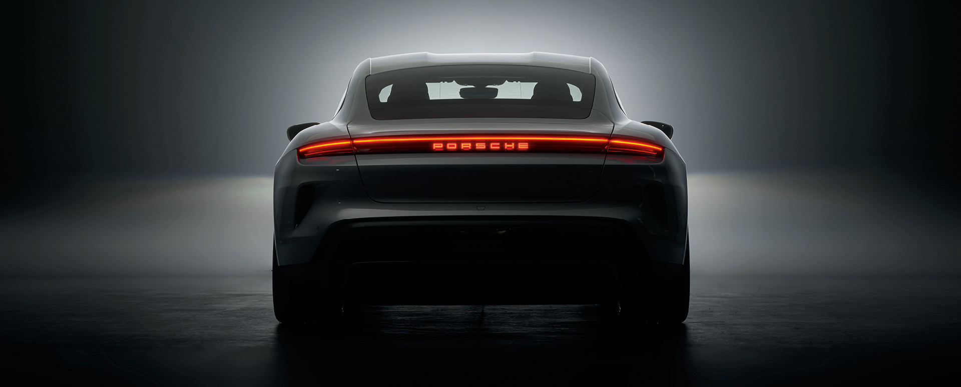 Silhouetted Rear Shot of Porsche Vehicle 