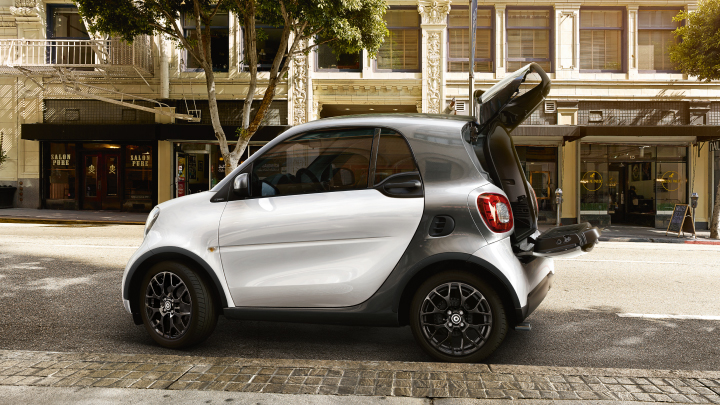White smart ForTwo parked on the road.