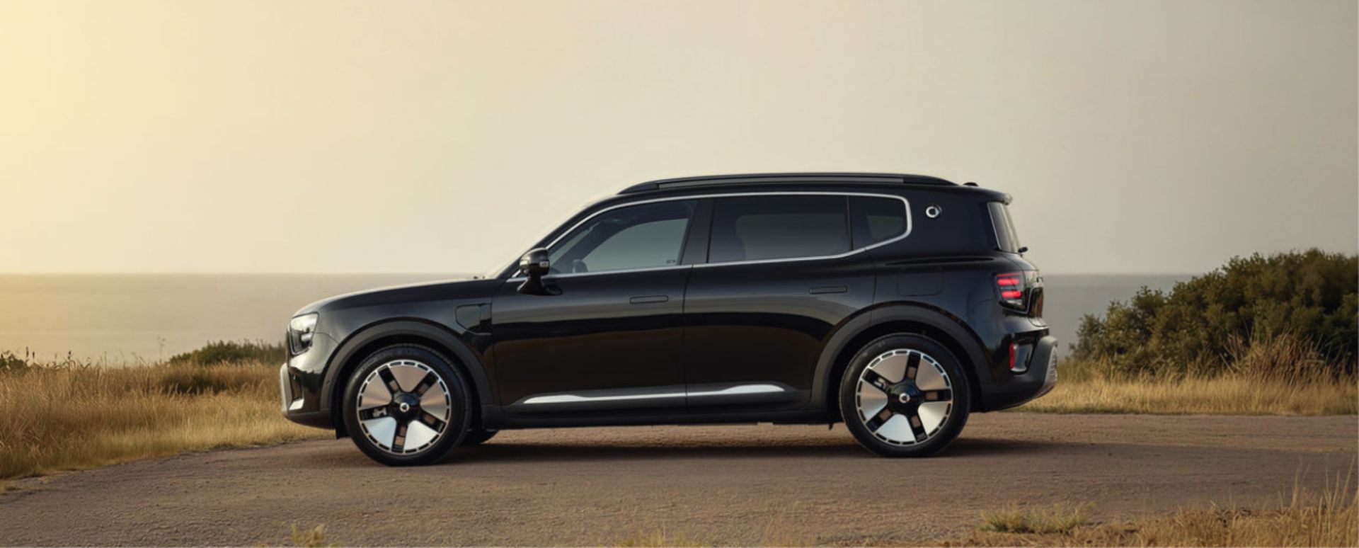Black Smart Electric Vehicle Parked On Dusty Road Side Angle