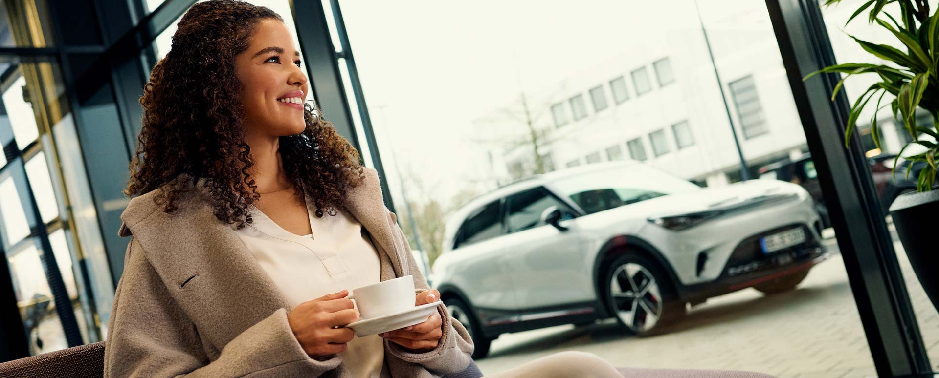 woman smiling next to smart vehicle