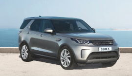 Grey Land Rover Discovery parked up.