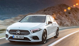 White Mercedes-Benz A-Class driving on the road.