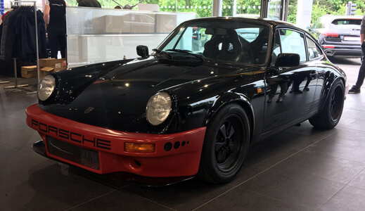 Black and red Porsche in the showroom.
